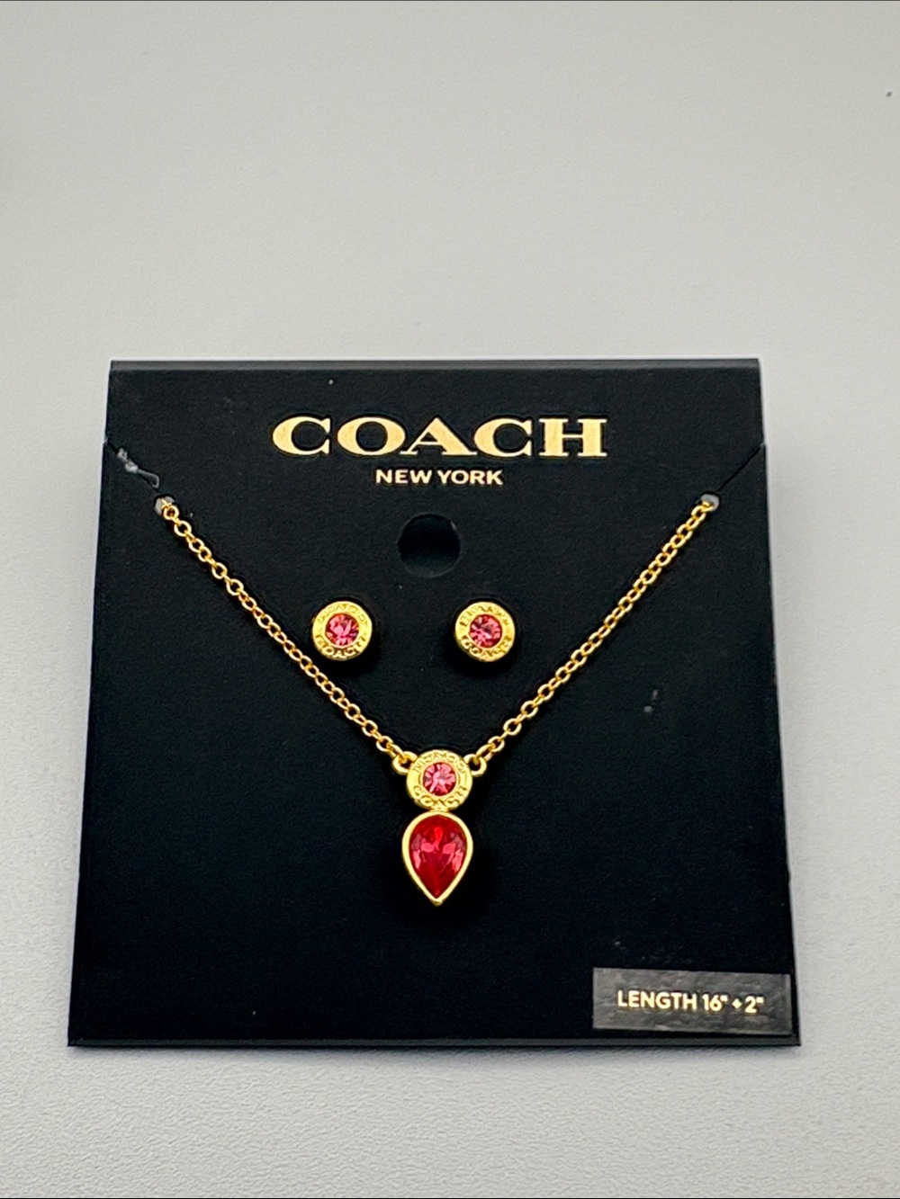 COACH Gold-Tone Necklace and Earring Set with Pink Stones